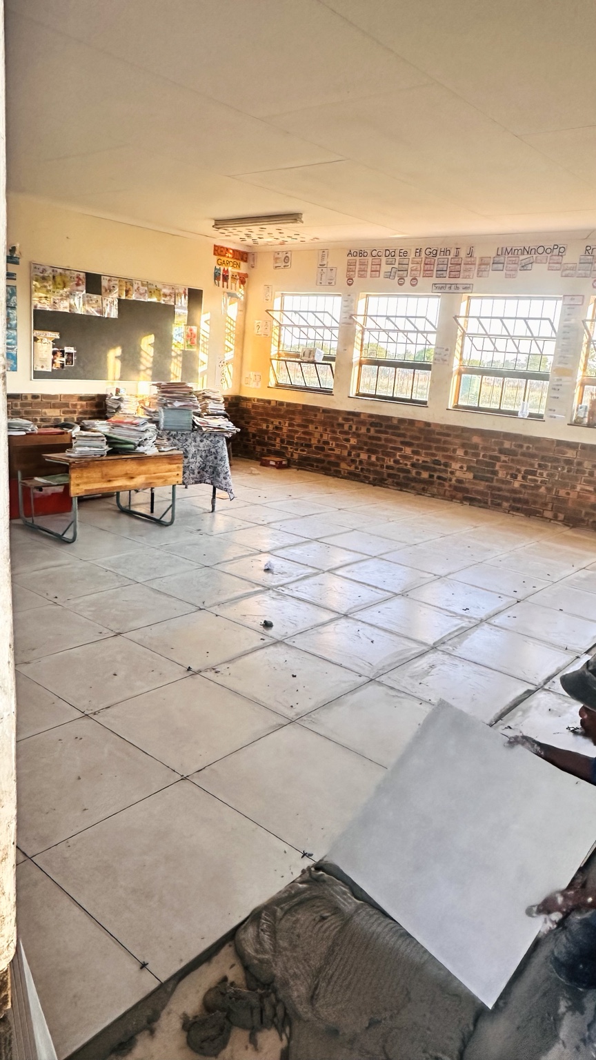 Large floor tiles being installed in a classroom at Rathoke Primary School